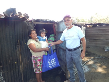 Ramiro Deliving Food bags at MIgrant Camp